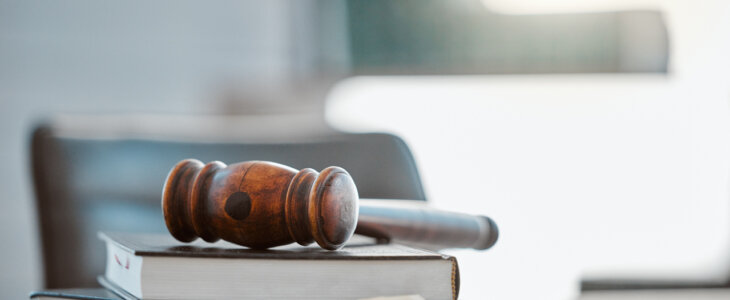 Justice, gavel and law books on table in office for court trial